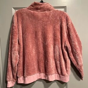 Warm snuggly pink unisex pullover sweater with a zipper.